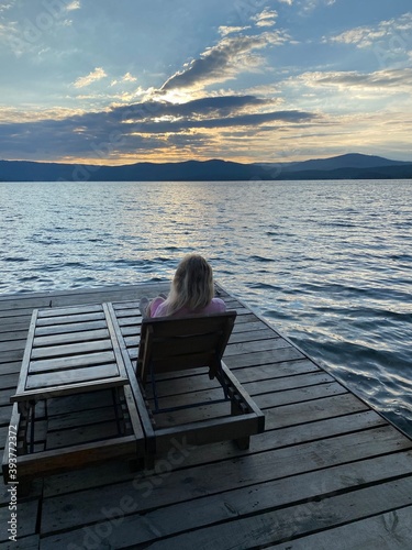 person sitting on a pier