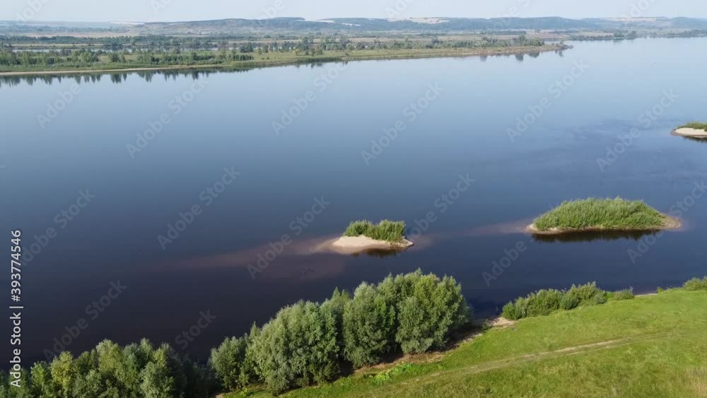 Top view of a wide full-flowing river with islands. Summer sunny day. Aerial photography Top view of a wide full-flowing river with islands. Summer sunny day. Aerial photography