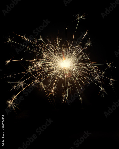 Glittering burning sparkler on black