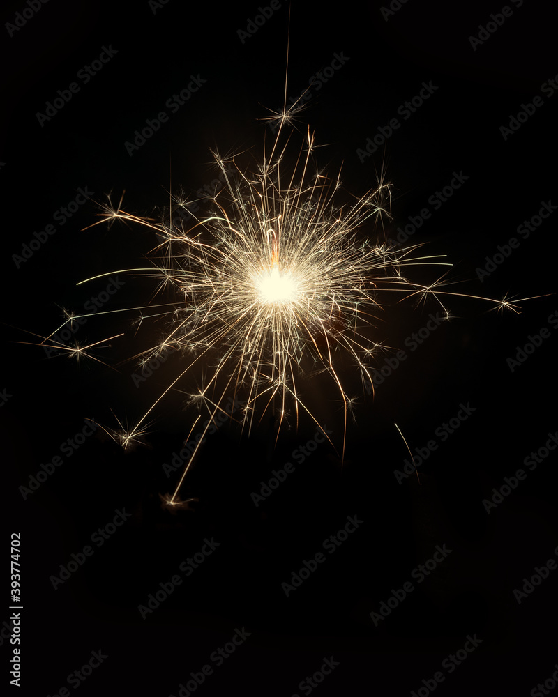 Glittering burning sparkler on black
