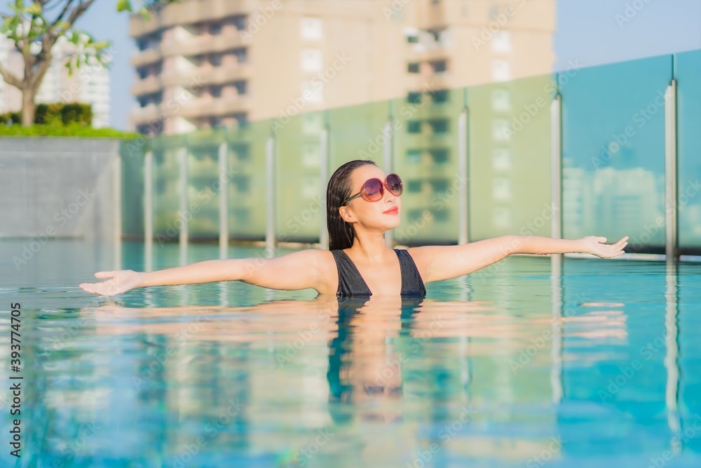 Portrait beautiful young asian woman relax smile around outdoor swimming pool