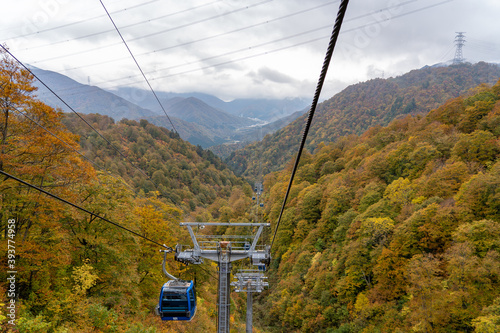 View of mountains and valleys from the Dragondola (Naeba-Tashiro Gondola) in autumn foliage season. Longest aerial gondola lift line in Japan. Naeba, Yuzawa, Niigata Prefecture, Japan. photo