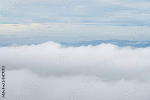 white thick clouds, dense clouds, aerial photo, calm light wallpapers, mountains, hills can be seen in the distance © Ольга Щербакова