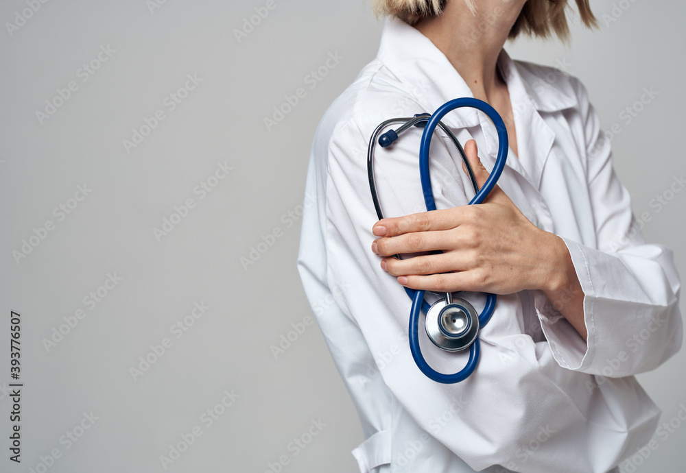 Professional doctor woman with blue stethoscope and white medical gown Professional doctor woman with blue stethoscope and white medical gown