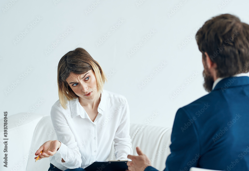 woman and man in suits are discussing something at work indoors woman and man in suits are discussing something at work indoors