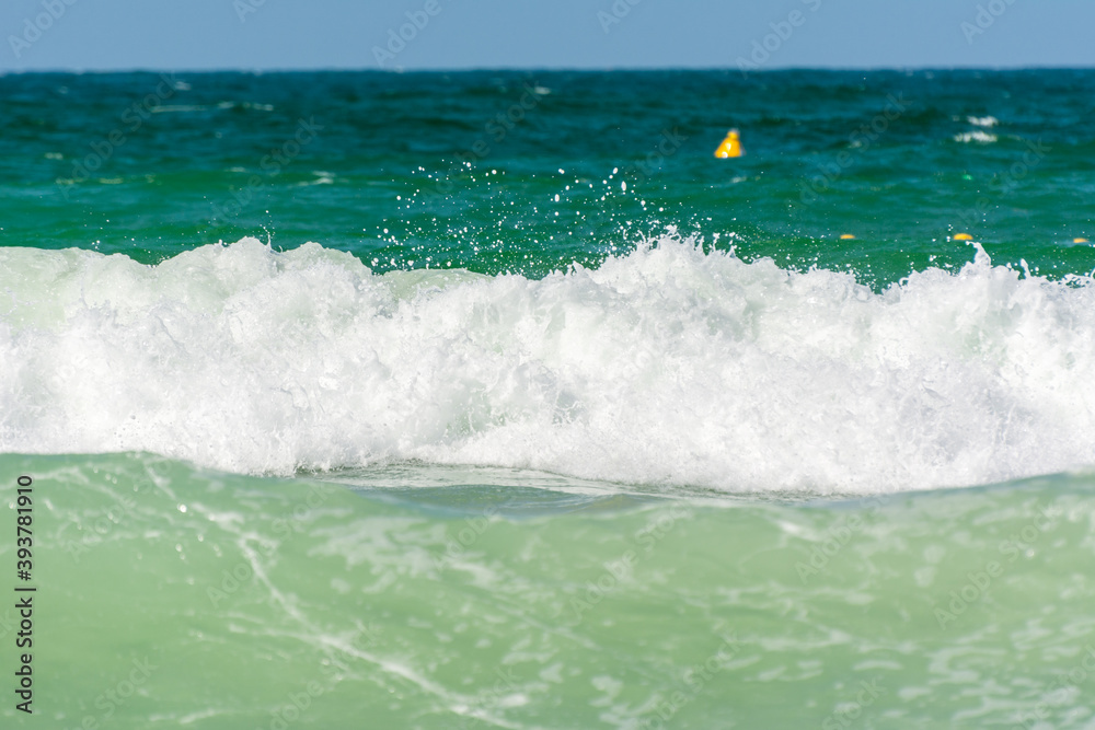 Waves, water splash flushing beach at Jumeirah beach at Persian gulf in Dubai, United Arab Emirates. Waves, water splash flushing beach at Jumeirah beach at Persian gulf in Dubai, United Arab Emirates.