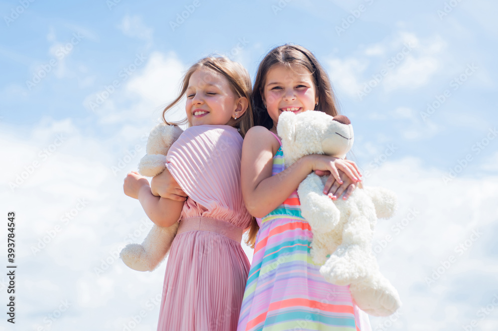 we are one. family bonding time. best friends hold bear toy. two sisters with teddy bear. happy childhood. summer vacation. small girls embrace. love and support. concept of sisterhood and friendship. we are one. family bonding time. best friends hold bear toy. two sisters with teddy bear. happy childhood. summer vacation. small girls embrace. love and support. concept of sisterhood and friendship.