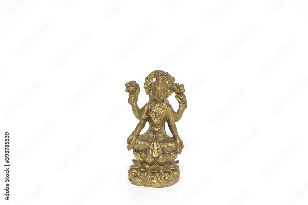 Brass figure of the Hindu goddess Lakshmi on white background.