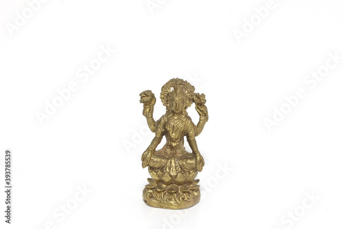 Brass figure of the Hindu goddess Lakshmi on white background. © alamo15