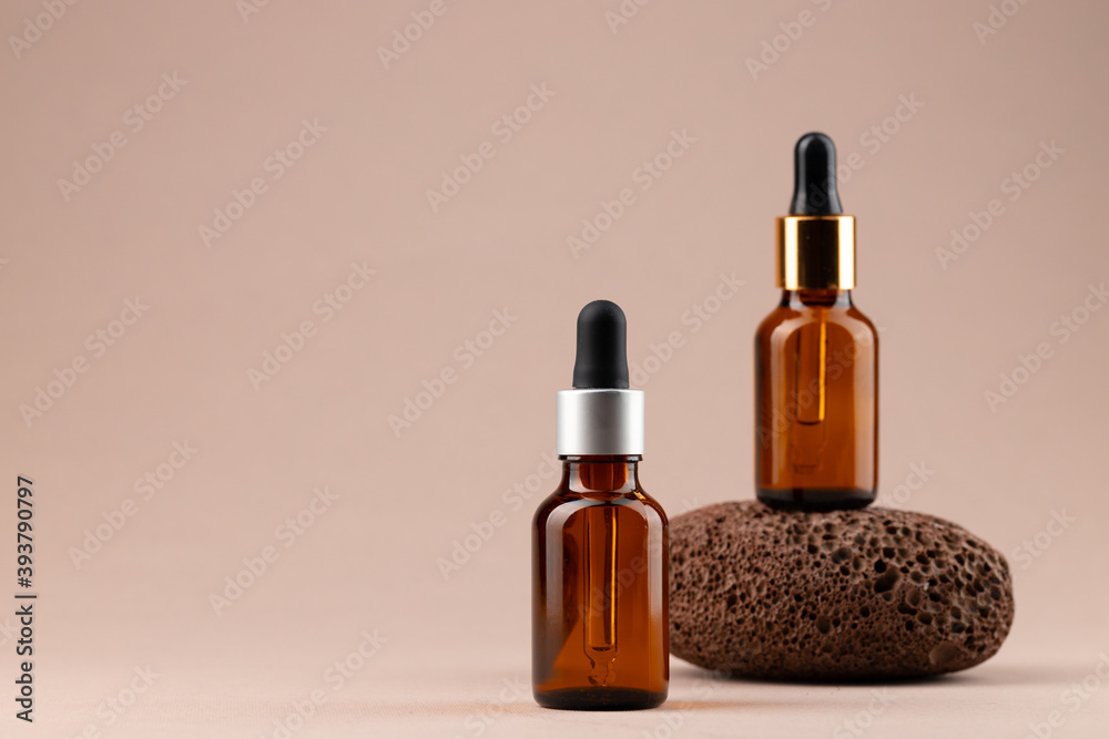 Beauty oil bottle with pipette on beige background Beauty oil bottle with pipette on beige background