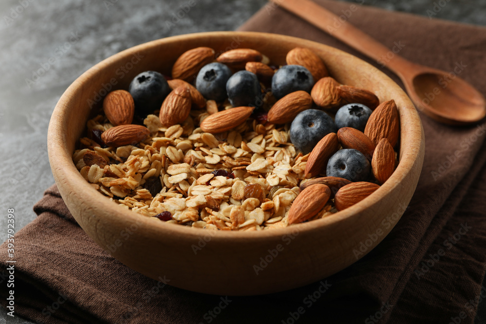 Napkin with bowl of granola on black smokey table Napkin with bowl of granola on black smokey table