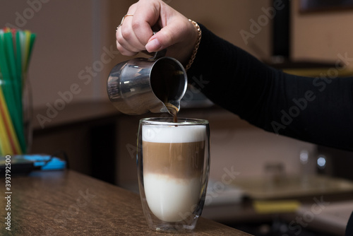 Barista girl pours coffee. Latte making process