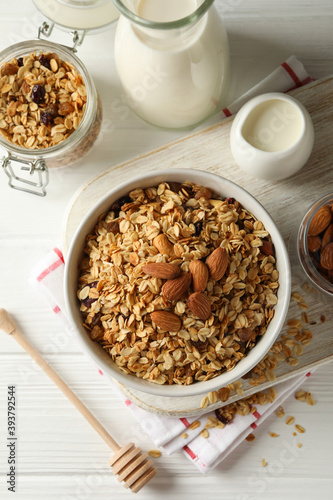 Concept of tasty breakfast with granola on white wooden background © Atlas