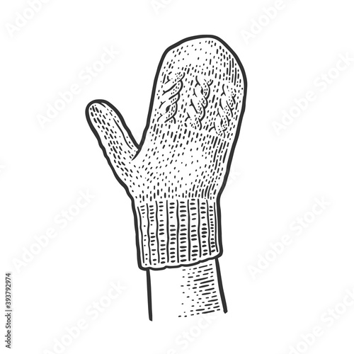 knitted woolen mitten on hand sketch engraving vector illustration. T-shirt apparel print design. Scratch board imitation. Black and white hand drawn image.