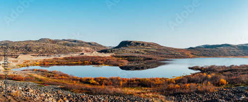 Mountains reflecting in the water, orange autumn tundra, Kola Peninsula. Mirror reflection, Barents Sea, mountain lakes