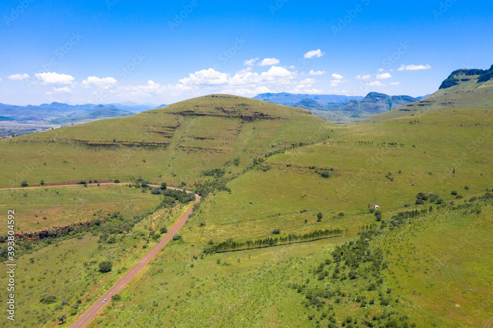 Aerial panoramic view of rugged mountain range on a clear day, with mountain plateau in the background.