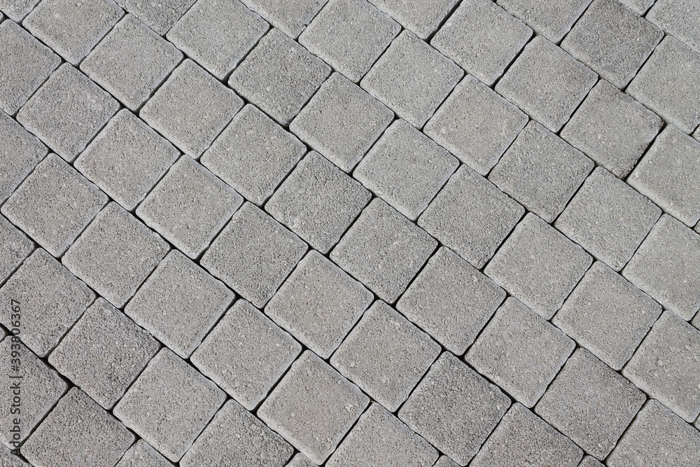 Pavement made of natural stone in the form of tiles. Texture background for designers. Pavement made of natural stone in the form of tiles. Texture background for designers.