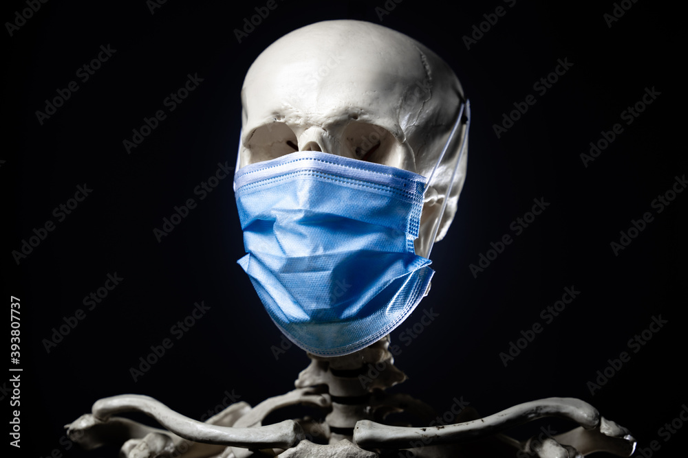 skeleton wearing blue face mask used by doctors and people for protection against corona and other virus diseases.