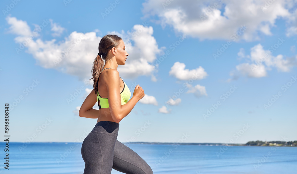 fitness, sport and healthy lifestyle concept - young woman running at seaside fitness, sport and healthy lifestyle concept - young woman running at seaside