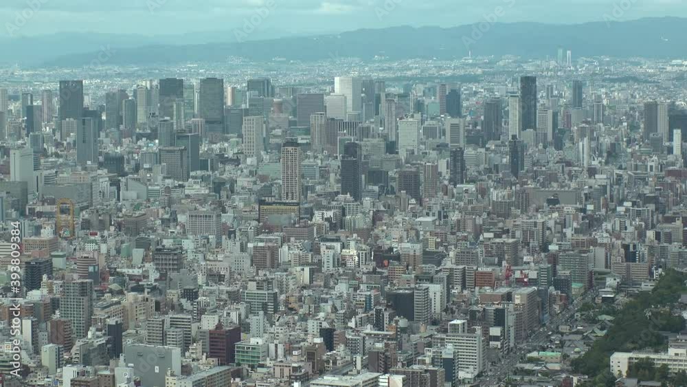 OSAKA, JAPAN : Aerial high angle view of CITYSCAPE of OSAKA in day time. View of buildings and streets around Namba, Shinsaibashi, Umeda and Osaka train station. Wide view time lapse tracking shot. OSAKA, JAPAN : Aerial high angle view of CITYSCAPE of OSAKA in day time. View of buildings and streets around Namba, Shinsaibashi, Umeda and Osaka train station. Wide view time lapse tracking shot.