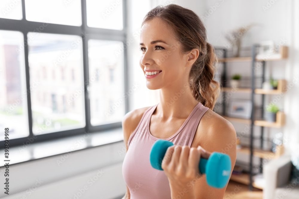 fitness, sport and healthy lifestyle concept - smiling young woman with dumbbells exercising at home fitness, sport and healthy lifestyle concept - smiling young woman with dumbbells exercising at home