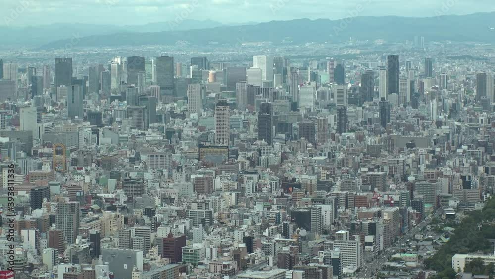 OSAKA, JAPAN : Aerial high angle view of CITYSCAPE of OSAKA in day time. View of buildings and streets around Namba, Shinsaibashi, Umeda and Osaka train station. Wide view time lapse tracking shot. OSAKA, JAPAN : Aerial high angle view of CITYSCAPE of OSAKA in day time. View of buildings and streets around Namba, Shinsaibashi, Umeda and Osaka train station. Wide view time lapse tracking shot.