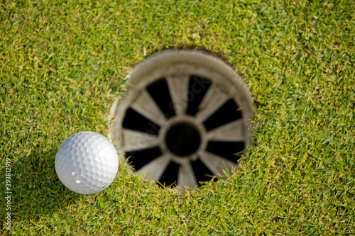 Close-up of golf ball near hole