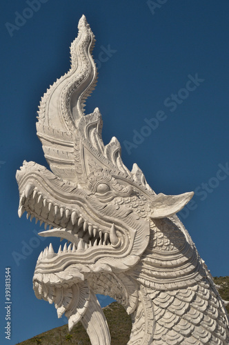 White chinese dragan statue in front of blue sky