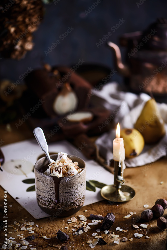 Hot chocolate with whipped cream and toasted almonds in a ceramic glass Hot chocolate with whipped cream and toasted almonds in a ceramic glass