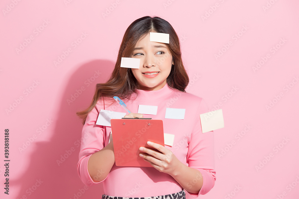 Funny portrait of busy female employee with many memo paper attached on body Funny portrait of busy female employee with many memo paper attached on body