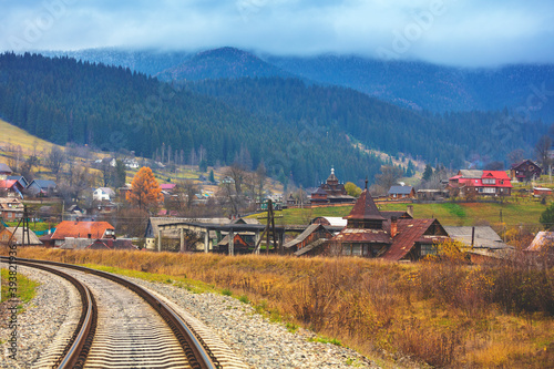 View of the city in the mountain valley and the railway in autumn