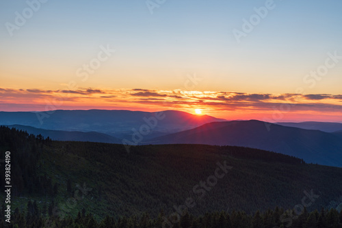 Sunset with colorful sky from Dlouhe strane hill in Jeseniky mountains in Czech republic