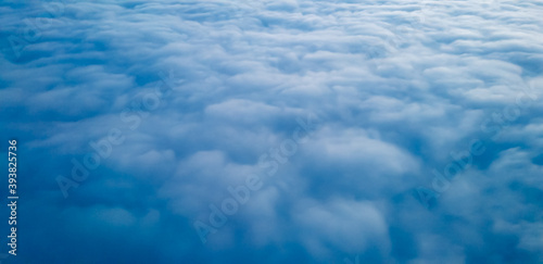 White clouds view at a height from a plane window