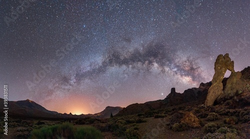a mountain and the sea night photography with the milky way and the stars