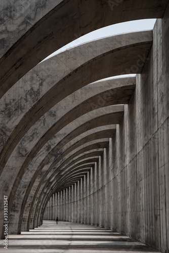 concrete structure in the shape of arches and the silhouette of a person