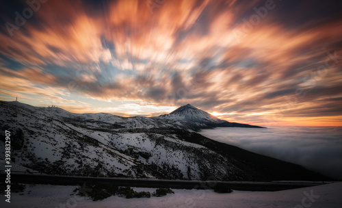 snowy landscape where you see a mountain and a cloudy sky