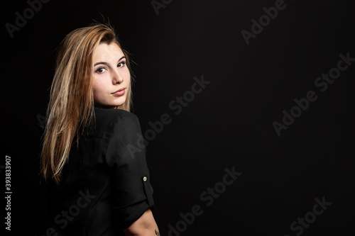 Studio portrait of a young beautiful girl with black background