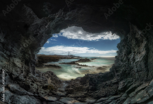 view of a lighthouse and the sea from inside a cave © Javier Gea