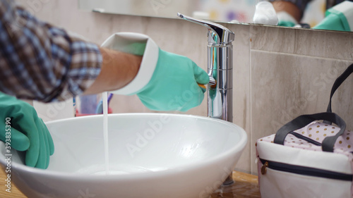 Fototapeta Naklejka Na Ścianę i Meble -  Close up of aged man in gloves doing bathroom cleaning