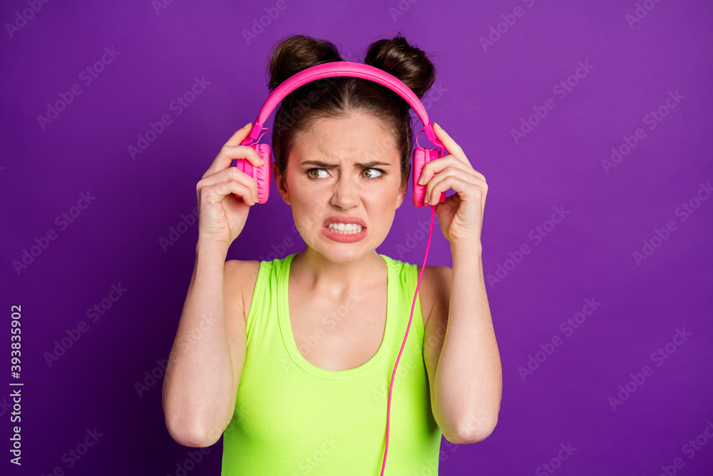 Close-up portrait of attractive mad interrupted girl fan listening single stereo grin teeth isolated over bright violet color background Close-up portrait of attractive mad interrupted girl fan listening single stereo grin teeth isolated over bright violet color background