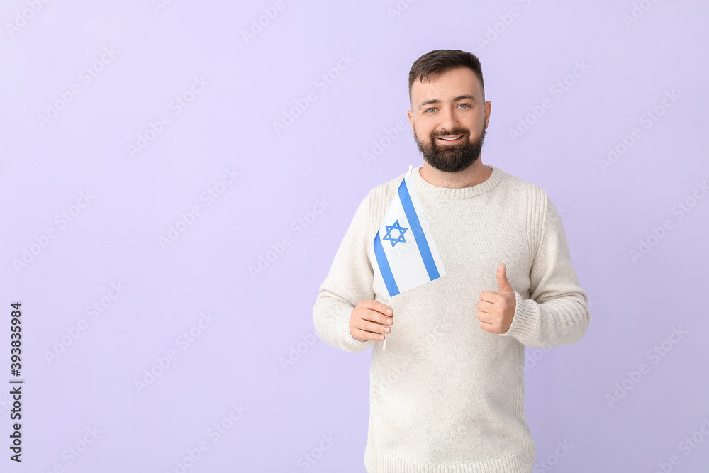 Man with the flag of Israel showing thumb-up on color background Man with the flag of Israel showing thumb-up on color background