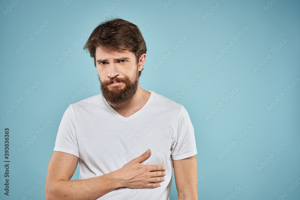 Man in white t-shirt emotions facial expression cropped view studio blue background lifestyle Man in white t-shirt emotions facial expression cropped view studio blue background lifestyle