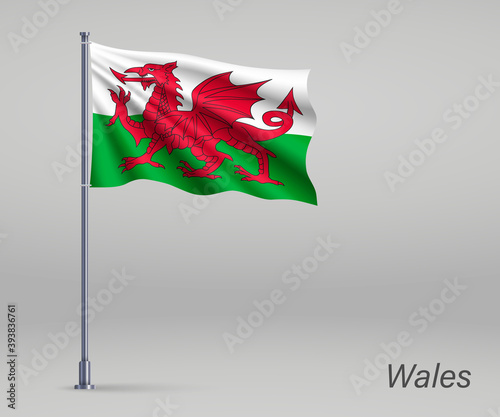 Obraz na plátně Waving flag of Wales - territory of United Kingdom on flagpole