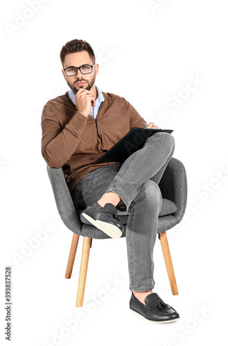 Male psychologist sitting i...