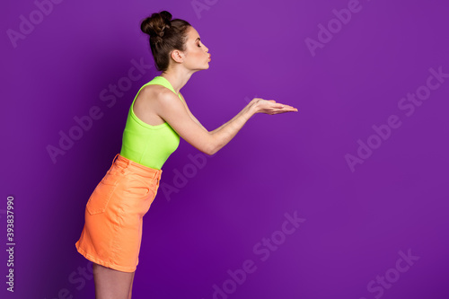 Profile side photo of girl hold hand send air kiss copyspace wear tank-top isolated violet shine color background