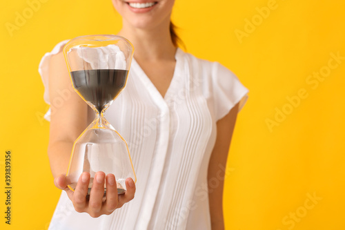 Young woman with hourglass ...