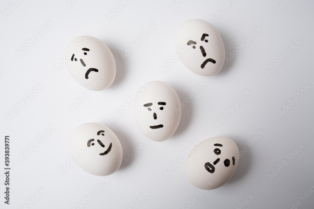 Eggs on a white background, with different emotions on their faces