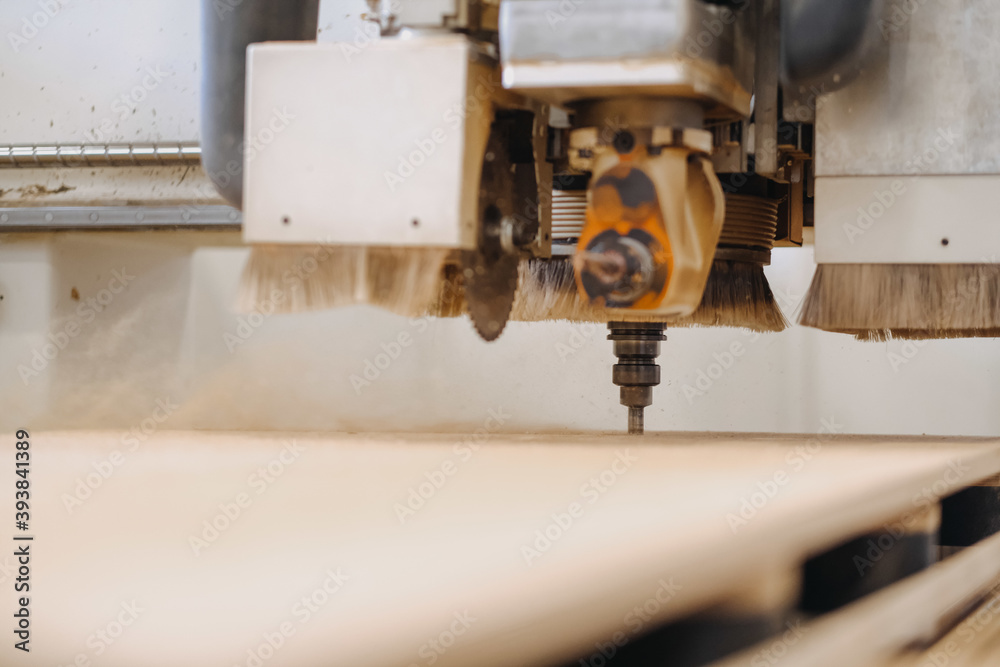 Closeup shot of an industrial working plywood carving machine Closeup shot of an industrial working plywood carving machine