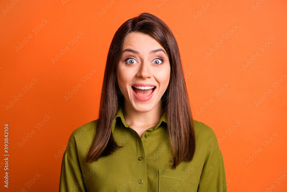Photo of pretty amazed girl look camera face mouth shiny smile wear green shirt isolated orange color background Photo of pretty amazed girl look camera face mouth shiny smile wear green shirt isolated orange color background