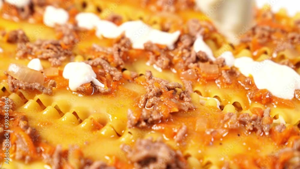 step-by-step laying of layers of lasagna into a baking dish. pasta casserole with red minced meat sauce (bolognese) and white sauce (bechamel). Italian cuisine at home. step-by-step laying of layers of lasagna into a baking dish. pasta casserole with red minced meat sauce (bolognese) and white sauce (bechamel). Italian cuisine at home.
